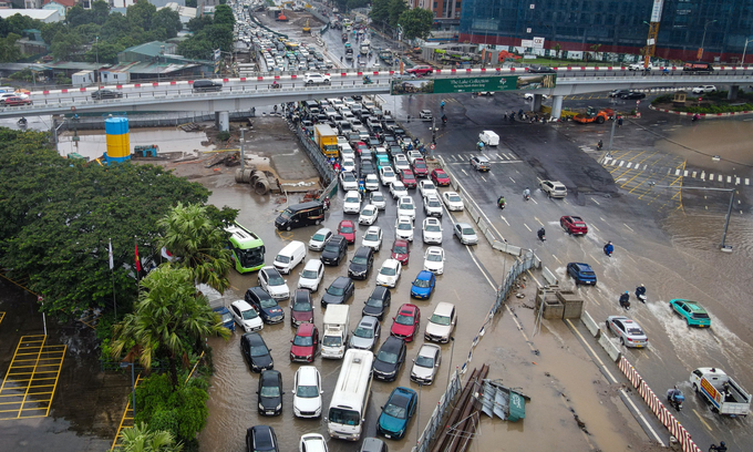 Hanoi paralyzed by flooding as commuters wade through streets