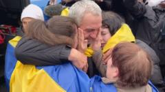Ukrainian evacuees reunite with families at Belarus border crossing