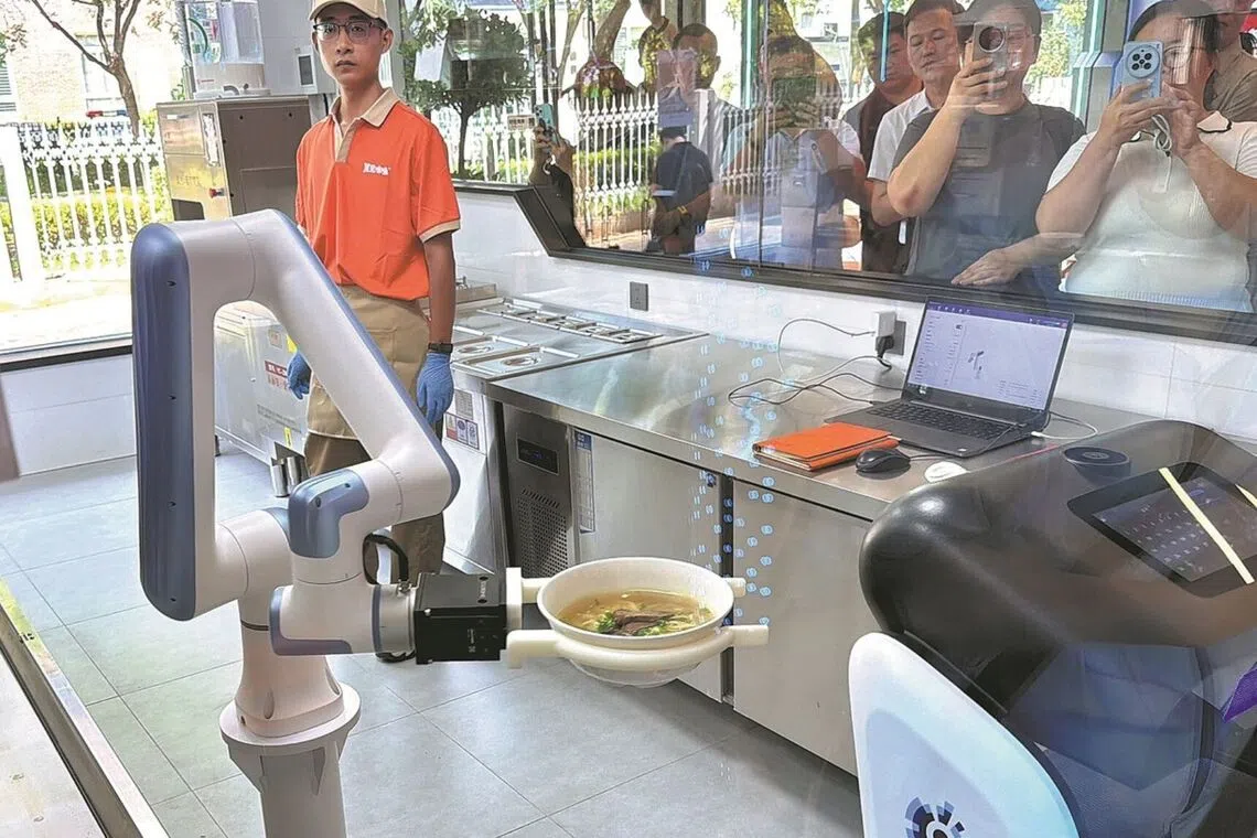 Beijing restaurant deploys robots to prepare and serve noodles