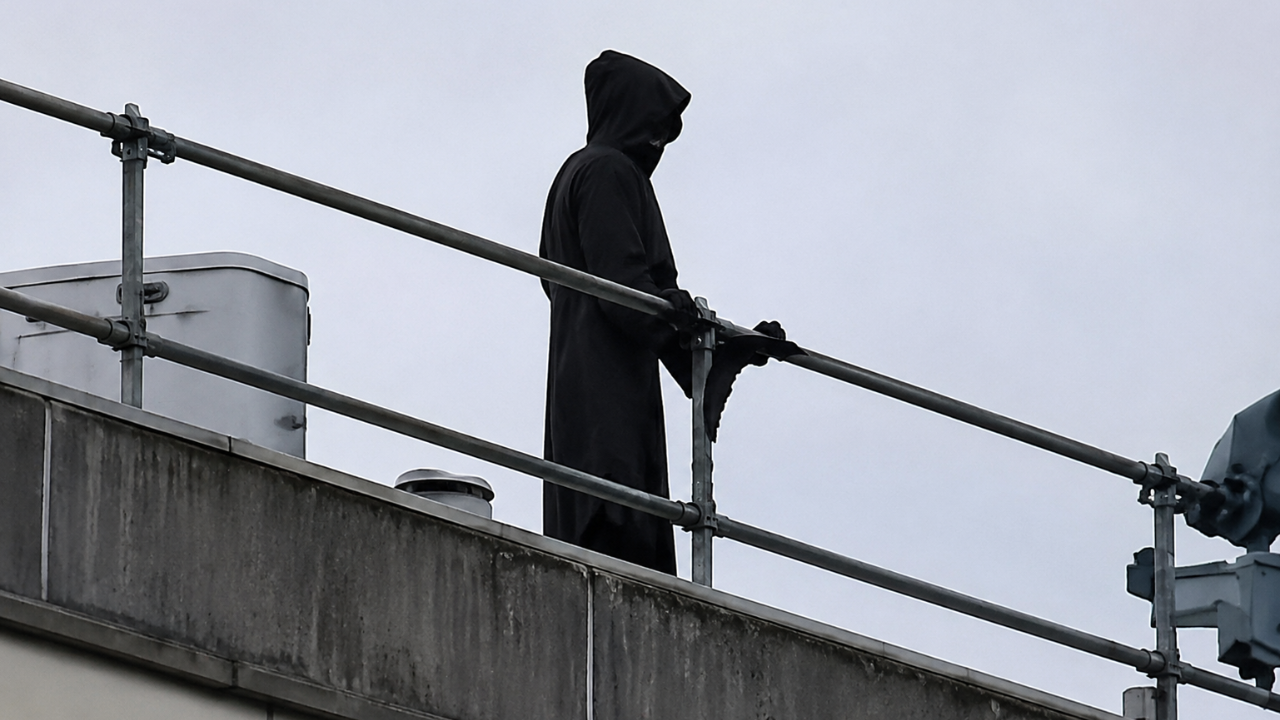 Man in Grim Reaper costume scales hospital roof, creates public alarm