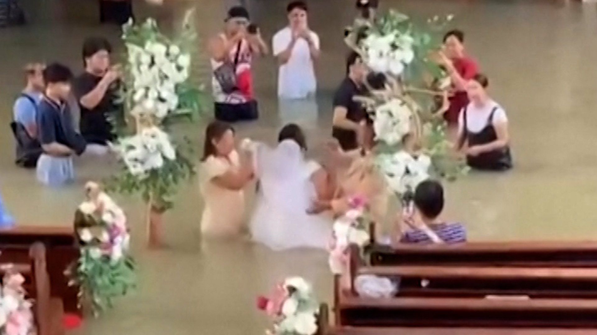 Philippine couple exchanges vows as floodwaters rise around them