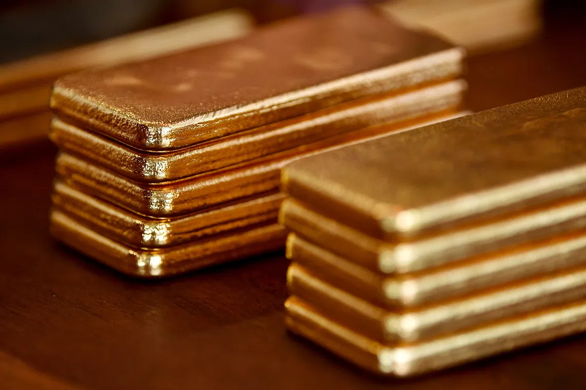 Gold surges as dollar weakens; Singapore's STI pressured by SATS