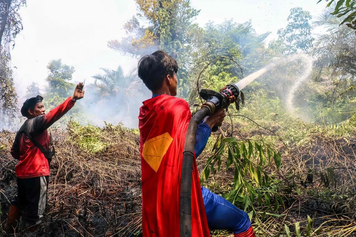 Indonesian teen in Superman costume joins battle against raging wildfires