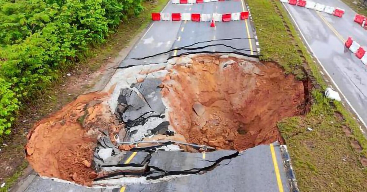 Major sinkhole closes Malaysian road as heavy rain raises subsidence risks