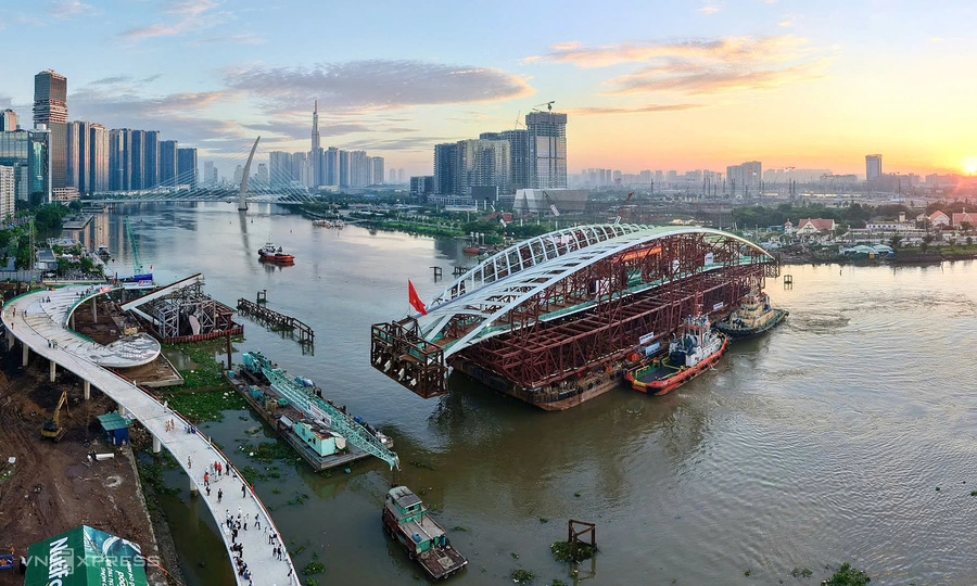 Giant steel arch rotated into place for Saigon River pedestrian bridge