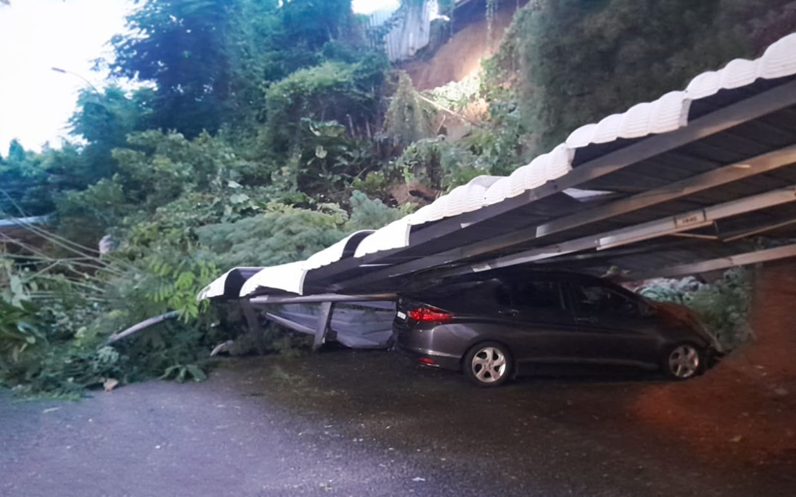 Landslide partially buries two vehicles in Tanjung Tokong