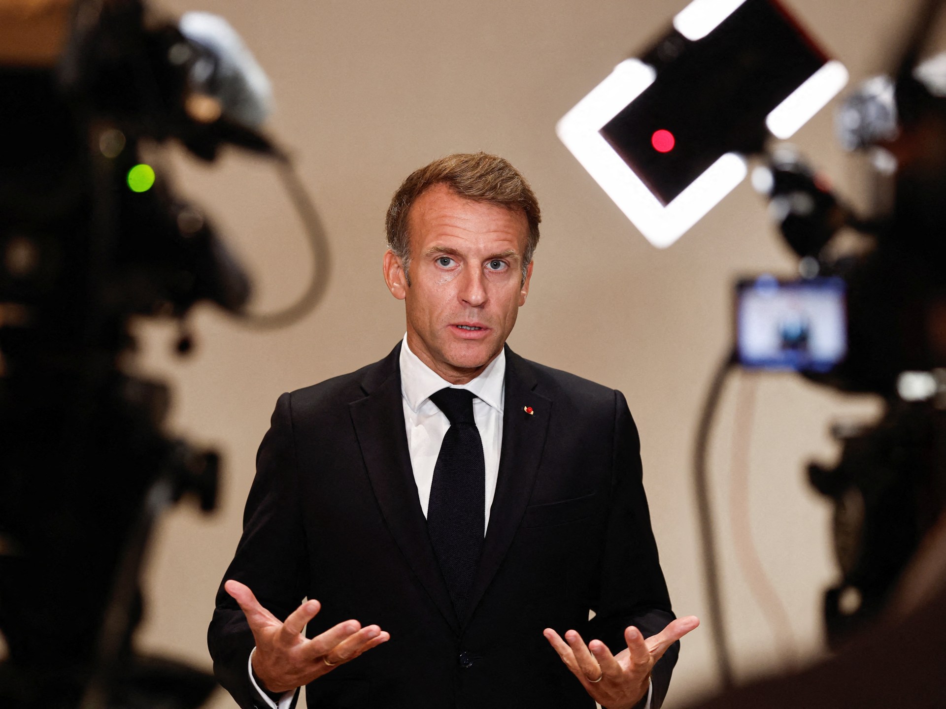 Macron vows firm response to protests, warns against foreign interference